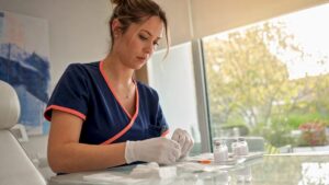 Nurse preparing biologic injection materials