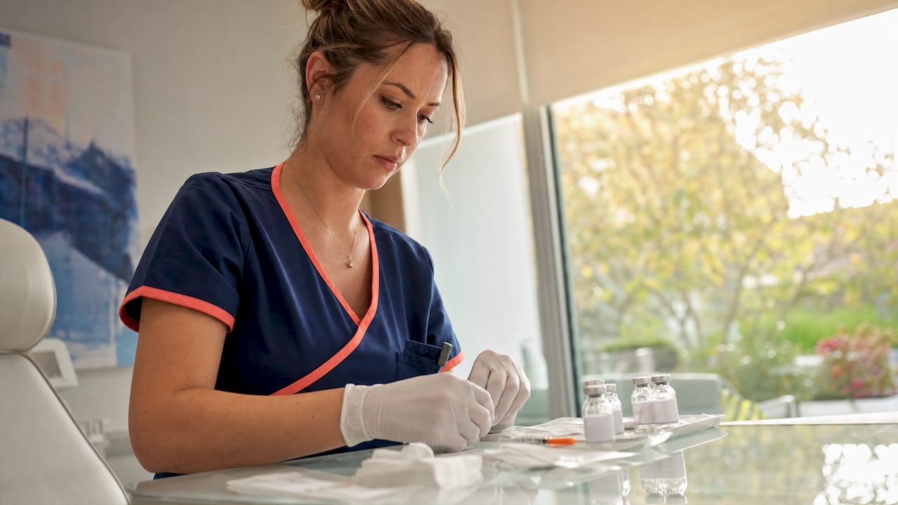 Nurse preparing biologic injection materials