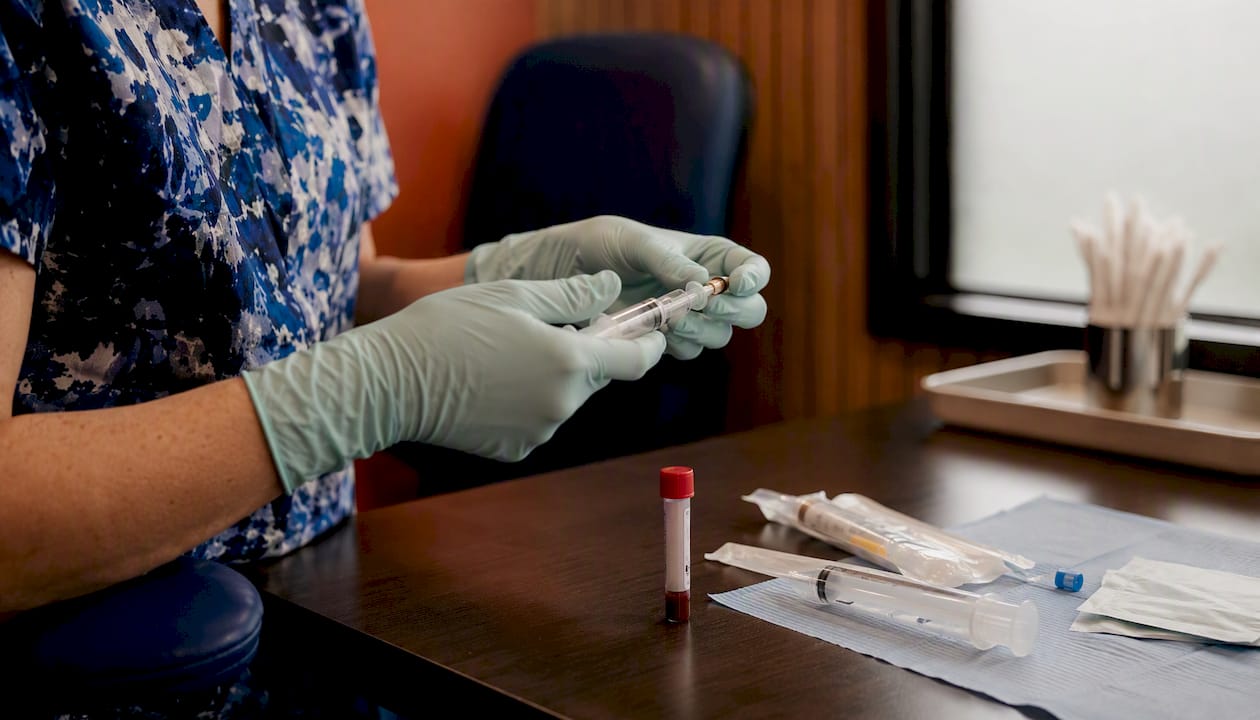 Nurse preparing PRP injection syringe